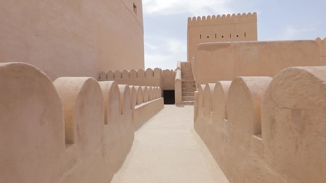 Nizwa Fort, Oman. Traditional Omani fortress, general plan and details. Camera movement along the corridor on the fortress wall.