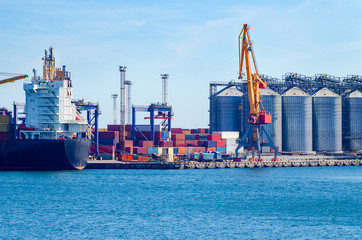 Port cargo crane loads a container onto a cargo ship