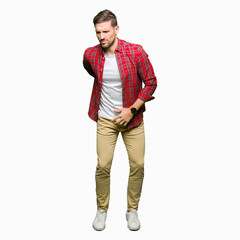 Handsome man wearing casual shirt Suffering of backache, touching back with hand, muscular pain