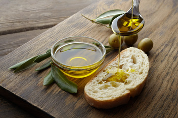 slice of bread seasoned with olive oil on wooden background - obrazy, fototapety, plakaty