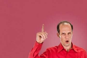 young man shows sign and symbol by hands on background punch shade pink