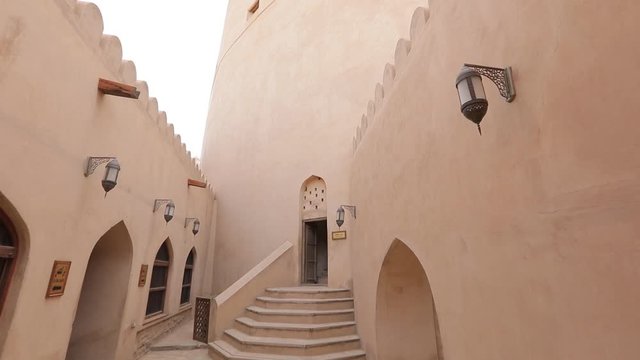 Nizwa Fort, Oman. Traditional Omani fortress, general plan and details. Camera movement along the corridor on the fortress wall.