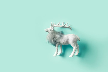 White Christmas reindeer on neo mint. Xmas background. Flat lay. View from above.