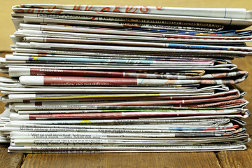 A stack of folded newspapers on the desktop