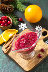 Cranberry sauce. Homemade Thanksgiving Cranberry Sauce with Orange Zest and ingredients for cooking on stone table.