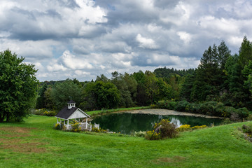 Fototapeta na wymiar large pond with abandoned gazeebo