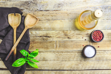 Cutting Board, rosemary and spices on a black wooden table.