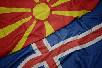 waving colorful flag of iceland and national flag of macedonia.