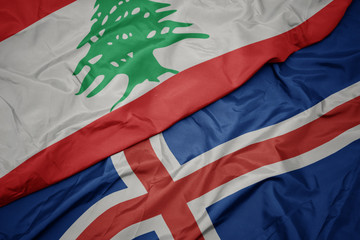 waving colorful flag of iceland and national flag of lebanon.