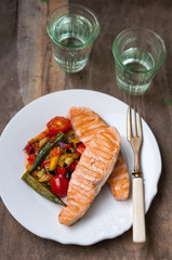 Grilled Salmon Steak with Sauteed Vegetables on White Plate.