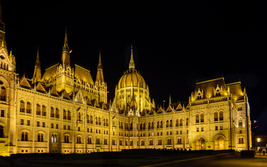 Fototapeta na wymiar Parliament is the most beautiful building in Budapest and the largest in Hungary. Embankment with palaces and residences in the lights. Architectural Style - Neo-Gothic