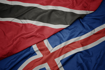 waving colorful flag of iceland and national flag of trinidad and tobago.
