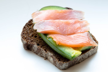 Brown bread sandwich with avocado and salmon