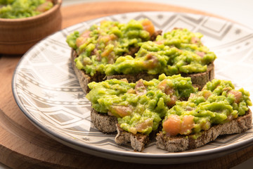 Brown bread sandwich with avocado and salmon
