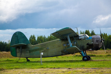 Vintage aircraft preparing for take-off on the background of a stormy sky