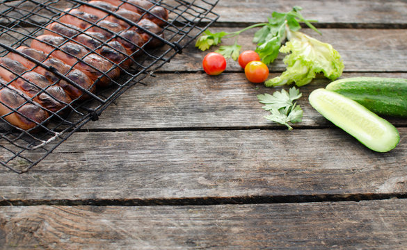 Tasty summer camping food on wooden table background