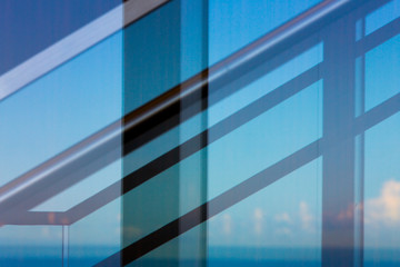 Metal stair railing abstraction against blue sky