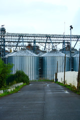 Storage tanks used for various food or petrochemical products. Refinery metal silos lined up in an industrial area.