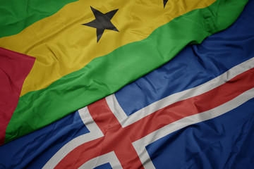 waving colorful flag of iceland and national flag of sao tome and principe .