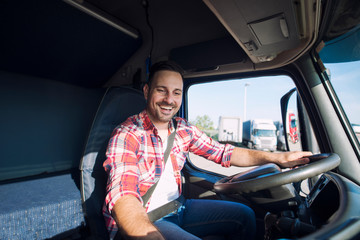 Truck driver driving his truck and changing radio station to play his favorite music. Trucker...