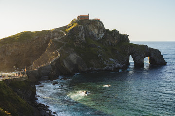 Fototapeta na wymiar Beautiful scenic view at sunset of the north coast of Spain, by the island of San Juan de Gaztelugatxe, a fortress in Basque Country