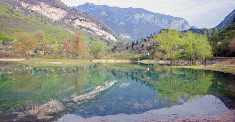 EMERAL WATER LAKE IN ITALY. ITALIAN LAKE CALLED LAGO DI TENNO IN TRENTINO ALTO ADIGE.