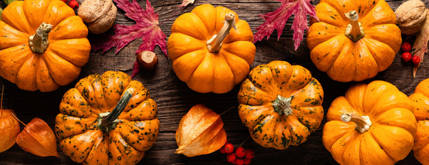 Autumn decorative pumpkins with fall leaves on wooden background. Thanksgiving or halloween holiday, harvest concept. Top view, copy space. Greeting card - Powered by Adobe