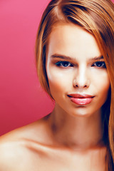 Fototapeta premium young pretty blonde real woman with hairstyle close up and makeup on pink background smiling, stylish fashion look like baby doll