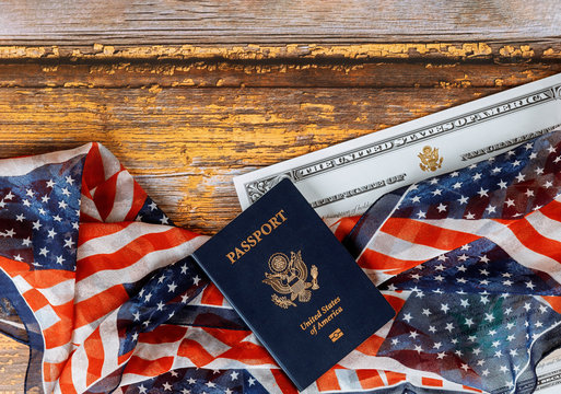 USA passport and naturalization certificate of citizenship US flag over wooden background