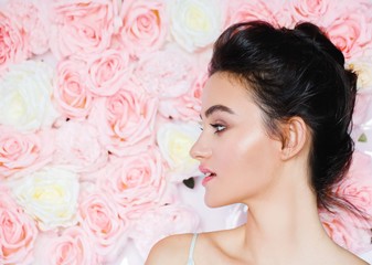 Obraz na płótnie Canvas Portrait of a beautiful fashion model Wedding make up and hair. Flowers background. 