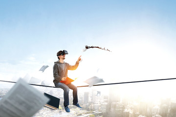 Virtual reality experience, young man in VR glasses