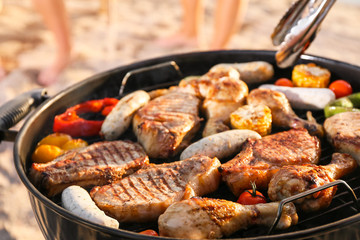 Cooking of tasty food on barbecue grill outdoors, closeup