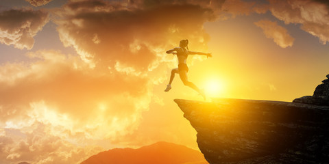 Obraz na płótnie Canvas Jumping over precipice, challenge concept.