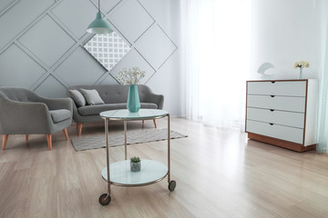 Vase with beautiful flowers in interior of room