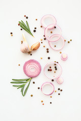 Fresh raw onions with spices on white background