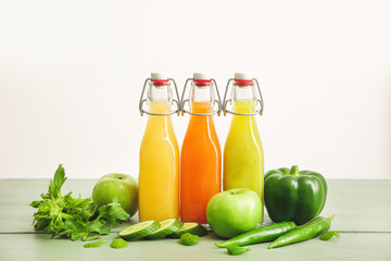 Obraz na płótnie Canvas Bottles of fresh juice on table