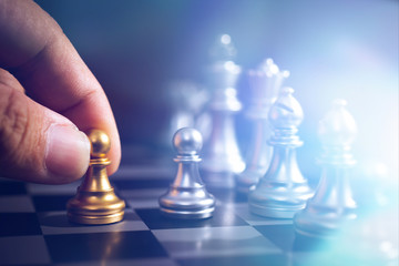 hand move back rank of chess boad game to practice planing and stratagy, business thinking concept