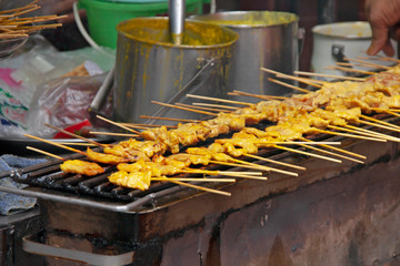 pork satay grill on hot stove,Pork satay is a street thai food ,light and delicious, suitable for snacks.