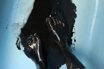 feet in black liquid