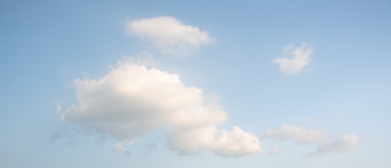 Large white clouds on the left and blue sky