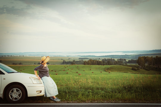 Woman in hat travel by car, rent a car in vacations, image with retro tone.