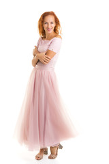 A beautiful young woman stands in the wind, the wind moves her c