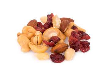 pile of mixed nuts and dried fruits isolated on white background, food for health