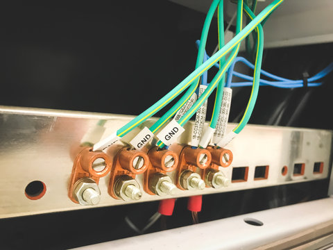 Green cables connected to the ground bar bus.