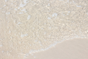 Ocean wave on sandy beach