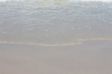 Ocean wave on sandy beach