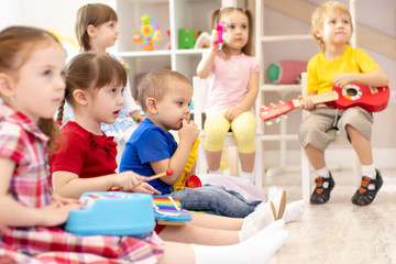 Group of preschooler children with toys on music lesson at kindergarten
