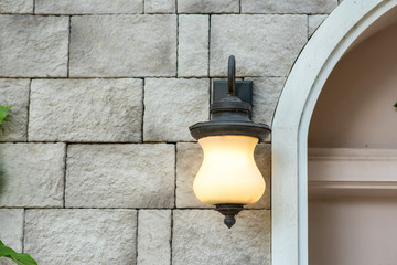 Orange light bulb, white wall backdrop