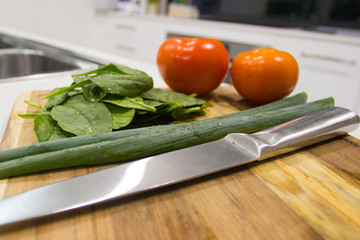 Chopping Board On A Kitchen Bench Full Of Fresh Healthy Vegetables And A Oven In The Background
