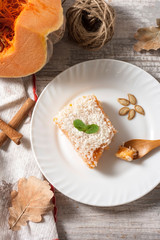 Slice of fresh homemade pumpkin pie and semolina on a white plate on a light background. . A Thanksgiving or holiday treat. Traditional autumn dish